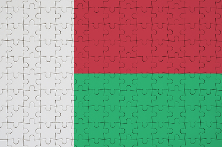 Madagascar flag  is depicted on a folded puzzleの写真素材