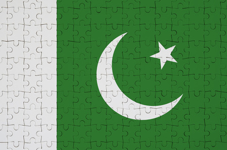 Pakistan flag  is depicted on a folded puzzleの写真素材