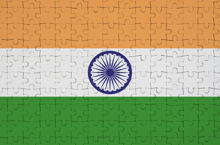 India flag  is depicted on a folded puzzleの写真素材