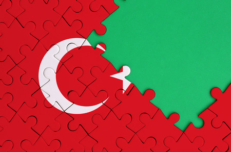 Turkey flag  is depicted on a completed jigsaw puzzle with free green copy space on the right side.の写真素材