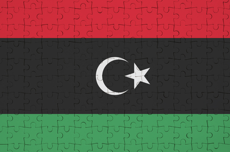 Libya flag  is depicted on a folded puzzleの写真素材