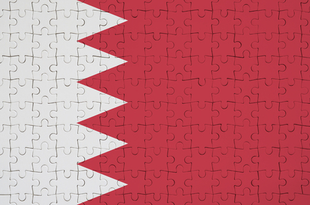 Bahrain flag  is depicted on a folded puzzleの写真素材