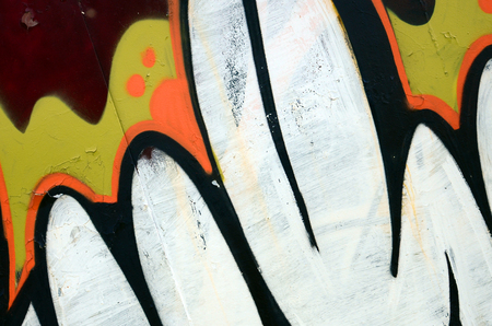 Street art. Abstract background image of a fragment of a colored graffiti painting in white and orange tones.の写真素材
