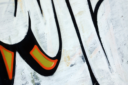 Street art. Abstract background image of a fragment of a colored graffiti painting in white and orange tones.の写真素材