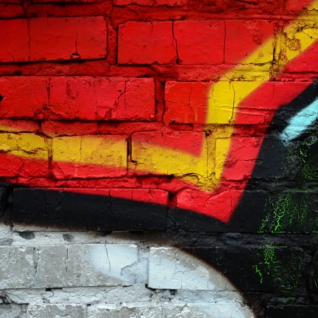 Street art. Abstract background image of a fragment of a colored graffiti painting in chrome and red...