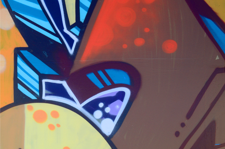 Street art. Abstract background image of a fragment of a colored graffiti painting in beige and orange tones.の写真素材