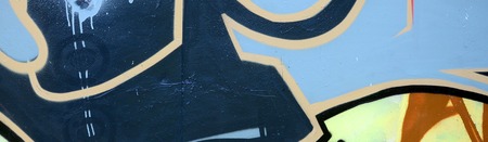 Street art. Abstract background image of a fragment of a colored graffiti painting in dark grey and...