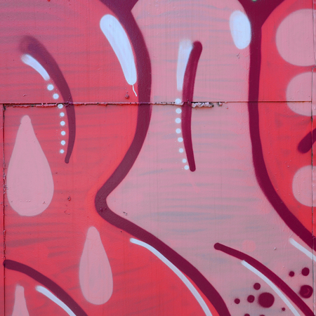 Street art. Abstract background image of a fragment of a colored graffiti painting in red tones.の写真素材