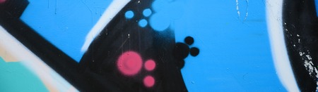 Street art. Abstract background image of a fragment of a colored graffiti painting in blue tones.
