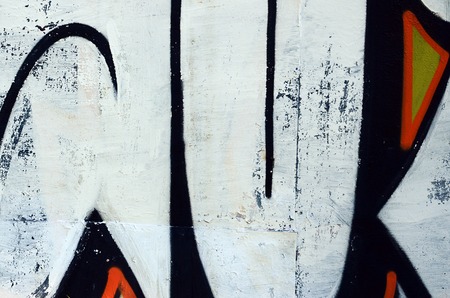 Street art. Abstract background image of a fragment of a colored graffiti painting in white and orange tones.の写真素材