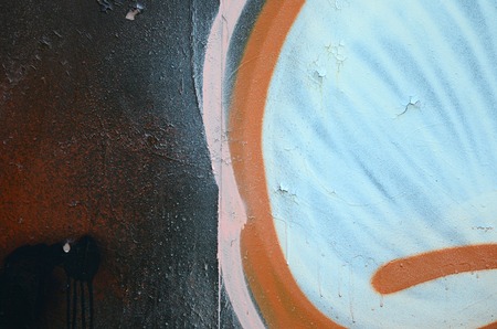 Street art. Abstract background image of a fragment of a colored graffiti painting in white and orange tones.の写真素材
