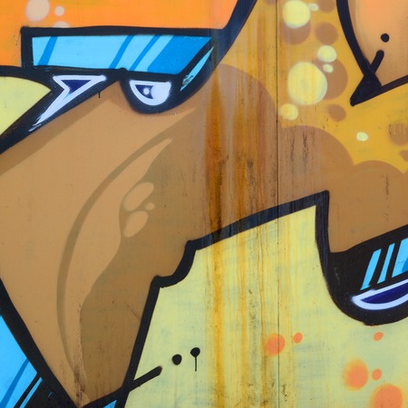 Street art. Abstract background image of a fragment of a colored graffiti painting in beige and orange tones.の写真素材