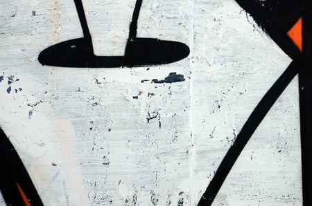 Street art. Abstract background image of a fragment of a colored graffiti painting in white and orange tones.の写真素材