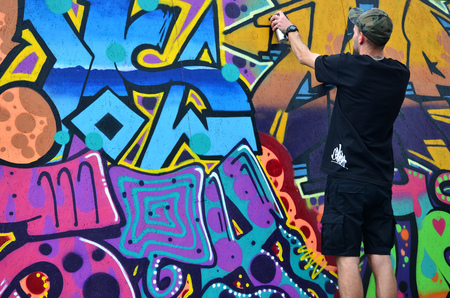 KHARKOV, UKRAINE - MAY 27, 2017: Festival of street arts. Young guys draw graffiti on portable wooden walls in the center of the city. The process of painting on walls with aerosol spray cansのeditorial素材