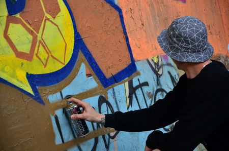 KHARKOV, UKRAINE - MAY 27, 2017: Festival of street arts. Young guys draw graffiti on an old concrete walls in the center of the city. The process of painting on walls with aerosol spray cansのeditorial素材