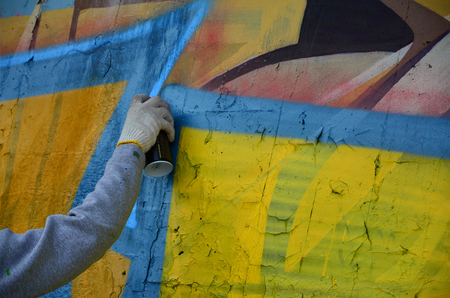 KHARKOV, UKRAINE - MAY 27, 2017: Festival of street arts. Young guys draw graffiti on an old concrete walls in the center of the city. The process of painting on walls with aerosol spray cansのeditorial素材