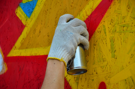 KHARKOV, UKRAINE - MAY 27, 2017: Festival of street arts. Young guys draw graffiti on portable wooden walls in the center of the city. The process of painting on walls with aerosol spray cansのeditorial素材