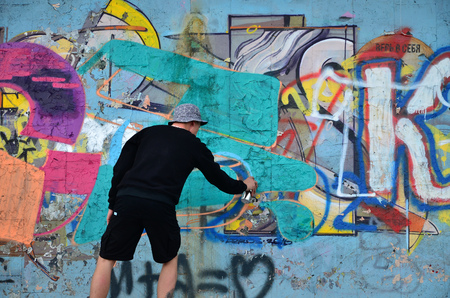 KHARKOV, UKRAINE - MAY 27, 2017: Festival of street arts. Young guys draw graffiti on an old concrete walls in the center of the city. The process of painting on walls with aerosol spray cansのeditorial素材