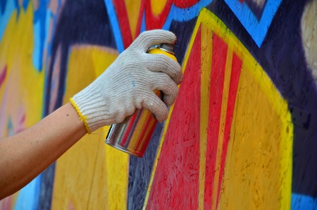 KHARKOV, UKRAINE - MAY 27, 2017: Festival of street arts. Young guys draw graffiti on portable wooden walls in the center of the city. The process of painting on walls with aerosol spray cansのeditorial素材