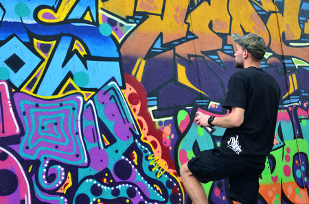 KHARKOV, UKRAINE - MAY 27, 2017: Festival of street arts. Young guys draw graffiti on portable wooden walls in the center of the city. The process of painting on walls with aerosol spray cansのeditorial素材