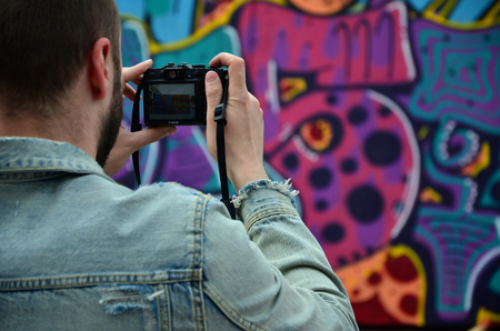 KHARKOV, UKRAINE - MAY 27, 2017: Festival of street arts. Young guys draw graffiti on portable wooden walls in the center of the city. The process of painting on walls with aerosol spray cansのeditorial素材