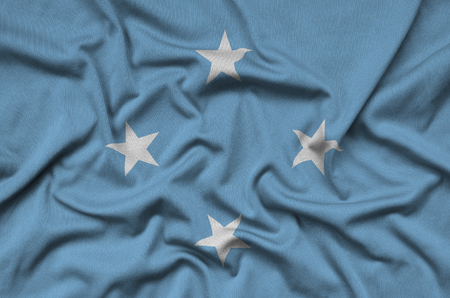 Micronesia flag  is depicted on a sports cloth fabric with many folds. Sport team waving bannerの写真素材