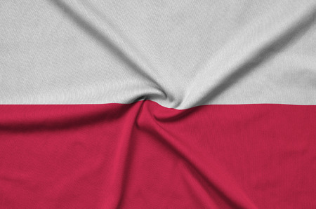 Poland flag  is depicted on a sports cloth fabric with many folds. Sport team waving bannerの写真素材