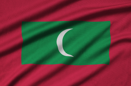 Maldives flag  is depicted on a sports cloth fabric with many folds. Sport team waving bannerの写真素材