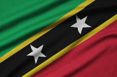 Saint Kitts and Nevis flag  is depicted on a sports cloth fabric with many folds. Sport team waving bannerの写真素材