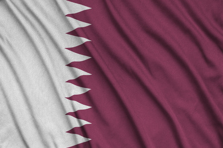 Qatar flag  is depicted on a sports cloth fabric with many folds. Sport team waving bannerの写真素材