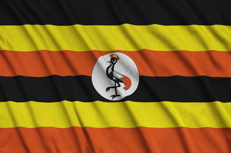 Uganda flag  is depicted on a sports cloth fabric with many folds. Sport team waving bannerの写真素材