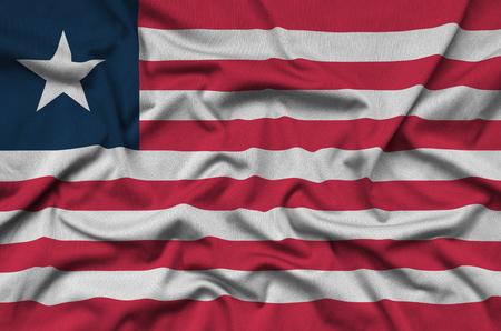 Liberia flag  is depicted on a sports cloth fabric with many folds. Sport team waving bannerの写真素材