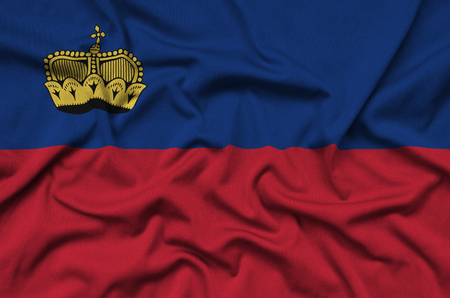 Liechtenstein flag  is depicted on a sports cloth fabric with many folds. Sport team waving bannerの写真素材