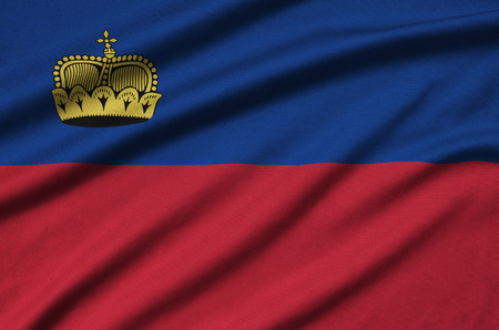Liechtenstein flag  is depicted on a sports cloth fabric with many folds. Sport team waving bannerの写真素材