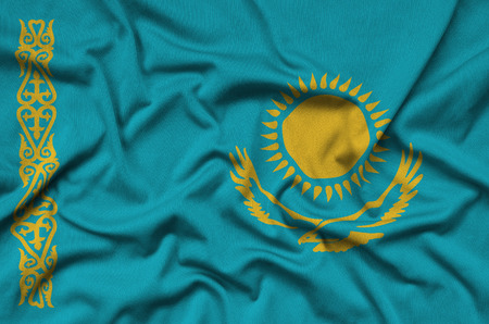 Kazakhstan flag  is depicted on a sports cloth fabric with many folds. Sport team waving bannerの写真素材