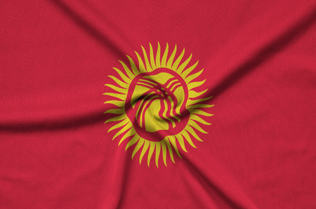 Kyrgyzstan flag  is depicted on a sports cloth fabric with many folds. Sport team waving bannerの写真素材
