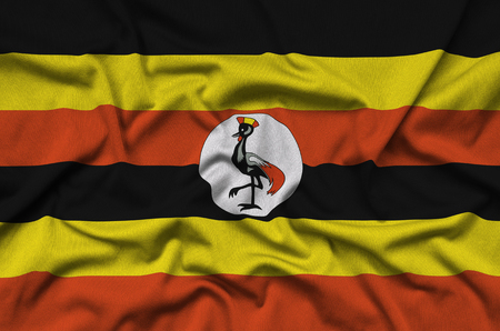 Uganda flag  is depicted on a sports cloth fabric with many folds. Sport team waving bannerの写真素材