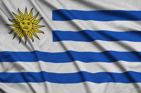 Uruguay flag  is depicted on a sports cloth fabric with many folds. Sport team waving bannerの写真素材