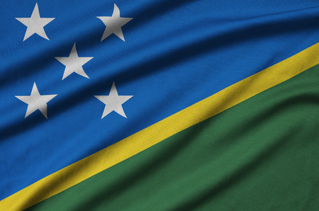 Solomon Islands flag  is depicted on a sports cloth fabric with many folds. Sport team waving bannerの写真素材