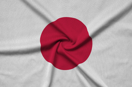 Japan flag  is depicted on a sports cloth fabric with many folds. Sport team waving bannerの写真素材