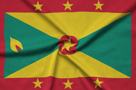 Grenada flag  is depicted on a sports cloth fabric with many folds. Sport team waving bannerの写真素材