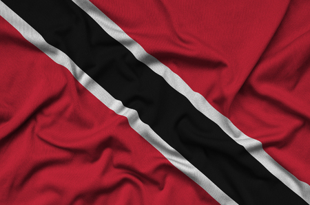 Trinidad and Tobago flag  is depicted on a sports cloth fabric with many folds. Sport team waving bannerの写真素材