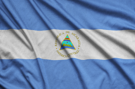 Nicaragua flag  is depicted on a sports cloth fabric with many folds. Sport team waving bannerの写真素材