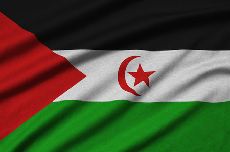 Western Sahara flag  is depicted on a sports cloth fabric with many folds. Sport team waving bannerの写真素材