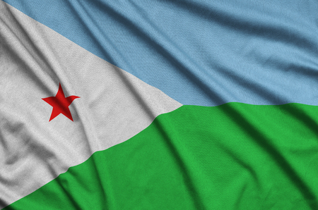 Djibouti flag  is depicted on a sports cloth fabric with many folds. Sport team waving bannerの写真素材