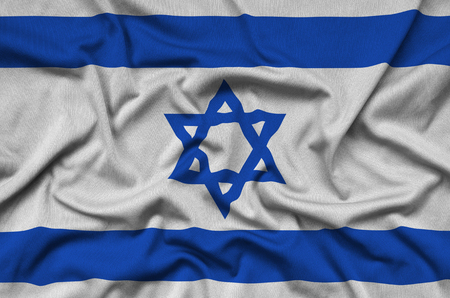 Israel flag  is depicted on a sports cloth fabric with many folds. Sport team waving bannerの写真素材