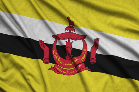 Brunei Darussalam flag  is depicted on a sports cloth fabric with many folds. Sport team waving...