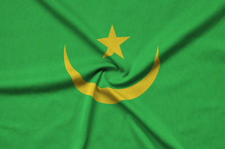 Mauritania flag  is depicted on a sports cloth fabric with many folds. Sport team waving bannerの写真素材