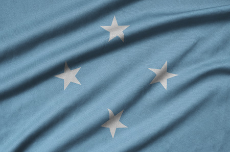 Micronesia flag  is depicted on a sports cloth fabric with many folds. Sport team waving bannerの写真素材