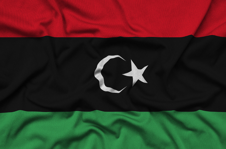 Libya flag  is depicted on a sports cloth fabric with many folds. Sport team waving bannerの写真素材